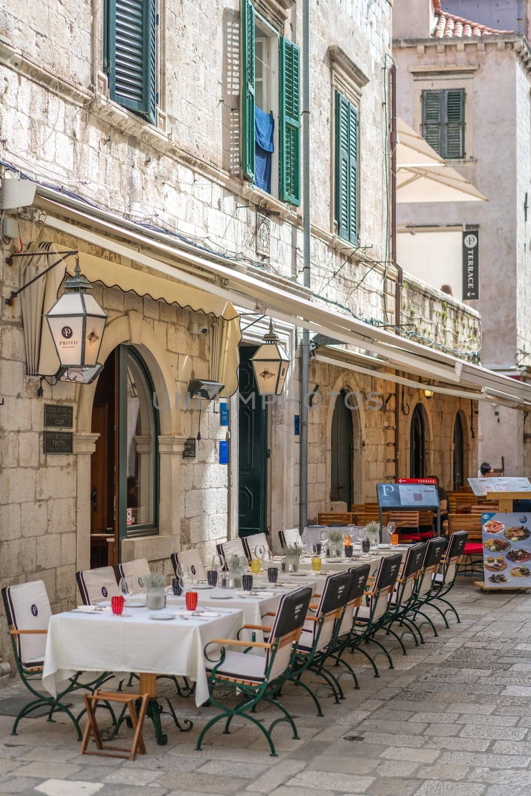 Dubrovnik, Croatia - April 2018 : Customer tables set up and ready for food service outside one of popular restaurants in Dubrovnik Old Town