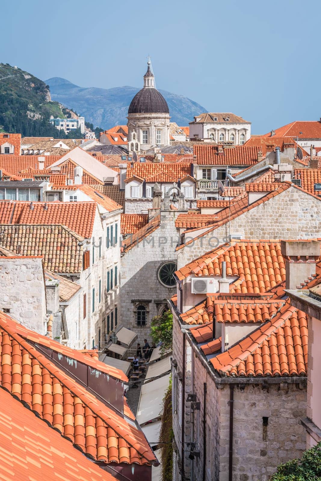 Dubrovnik, Croatia - April 2018 : Church bell tower dome and rooftops of old houses in Dubrovnik, viewed from the Old Town fortified walls