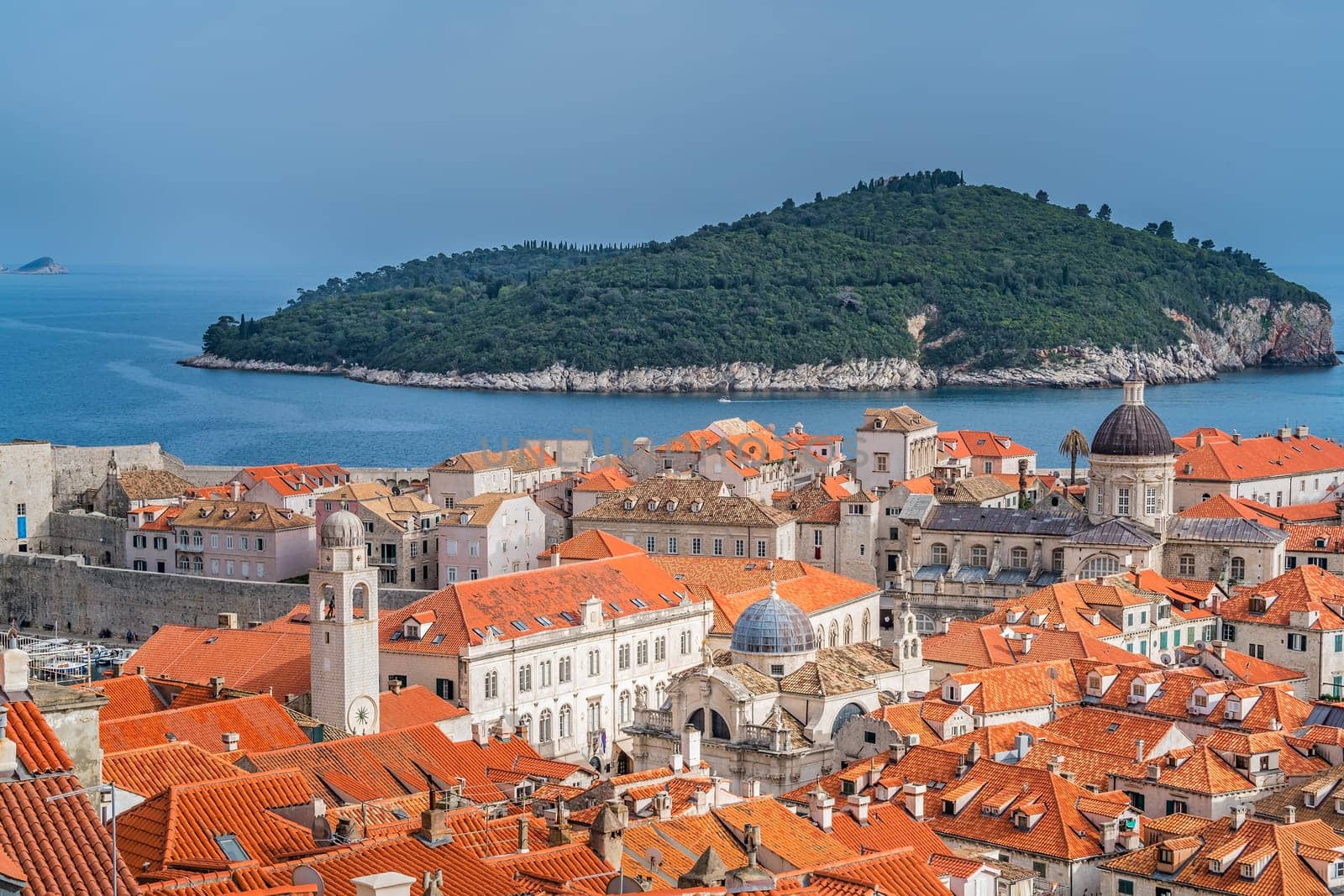 Dubrovnik, Croatia - April 2018 : Rooftops of old houses in Dubrovnik, viewed from the Old Town fortified walls with Lokrum Island in the background
