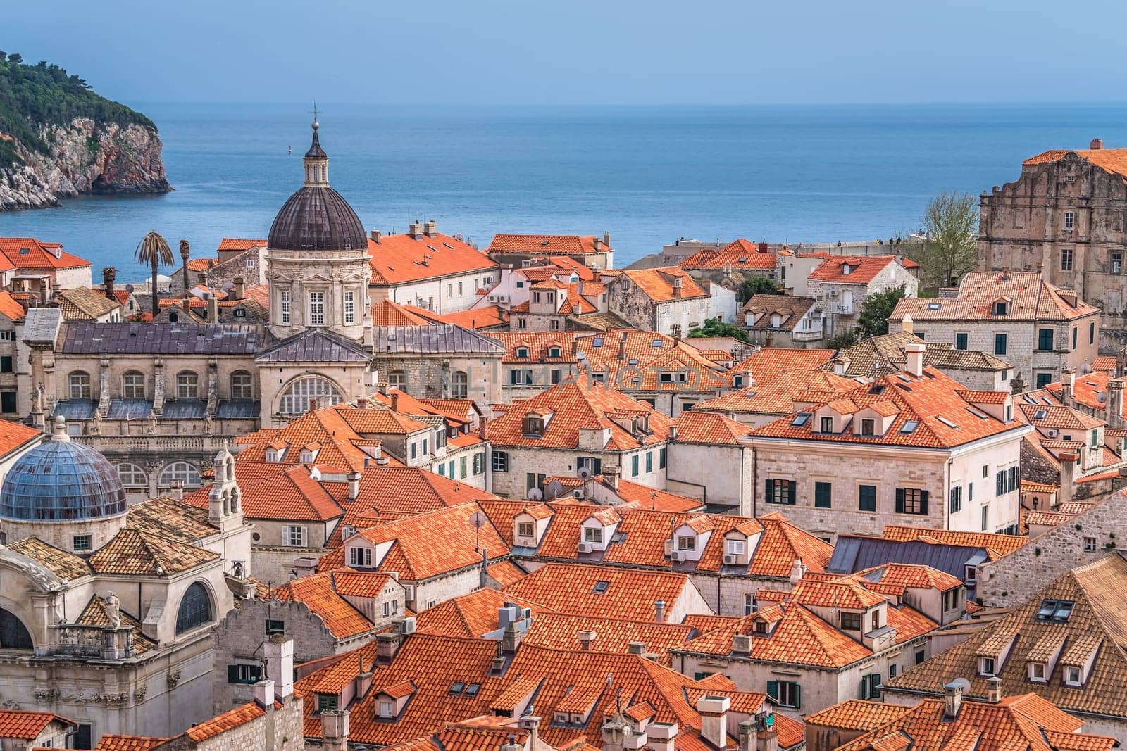 Dubrovnik, Croatia - April 2018 : Rooftops of old houses in Dubrovnik, viewed from the Old Town fortified walls with Lokrum Island in the background
