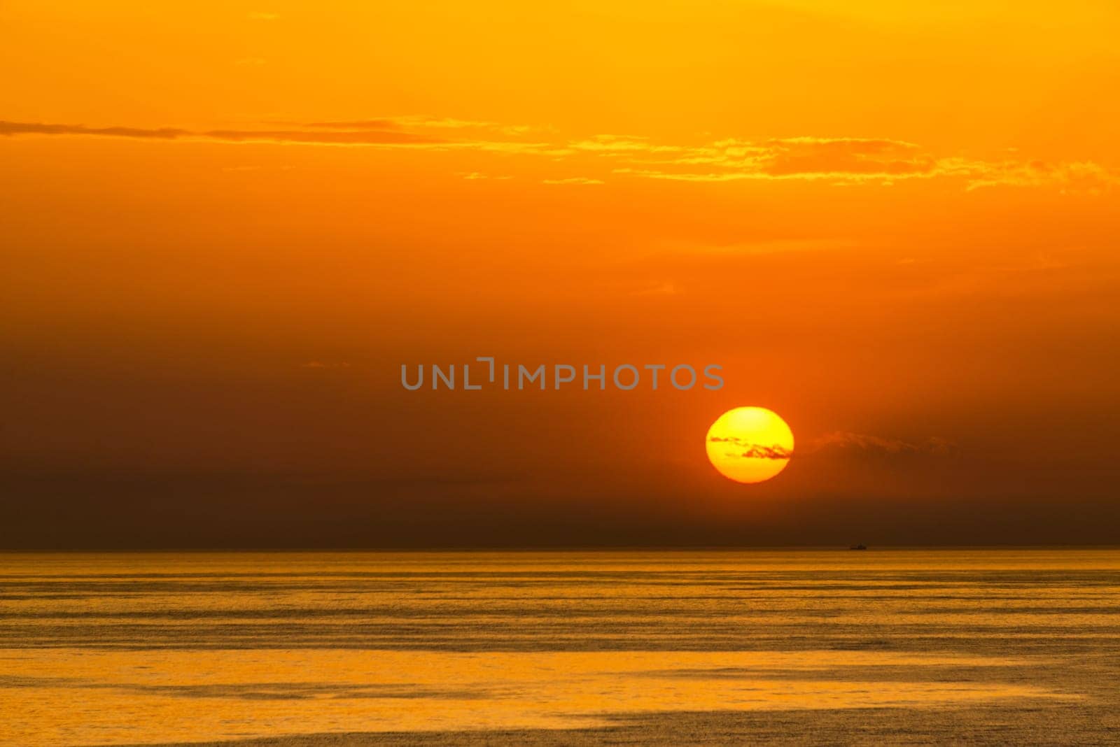 Fiery orange sunrise off the coast of Sicily in Palermo, Italy