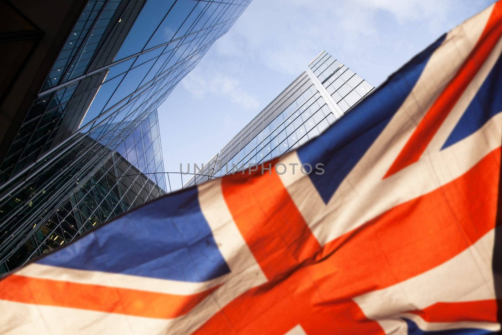 brexit concept - UK economy after Brexit deal - double exposure of flag and Canary Wharf business center skyscrapers