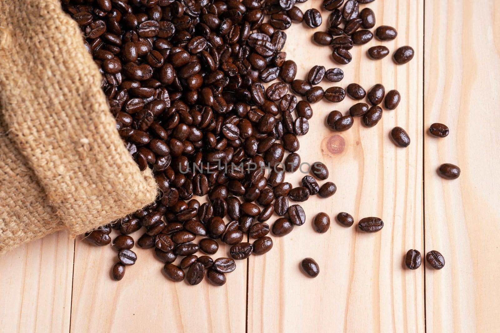 Coffee beans spilled out from burlap sack