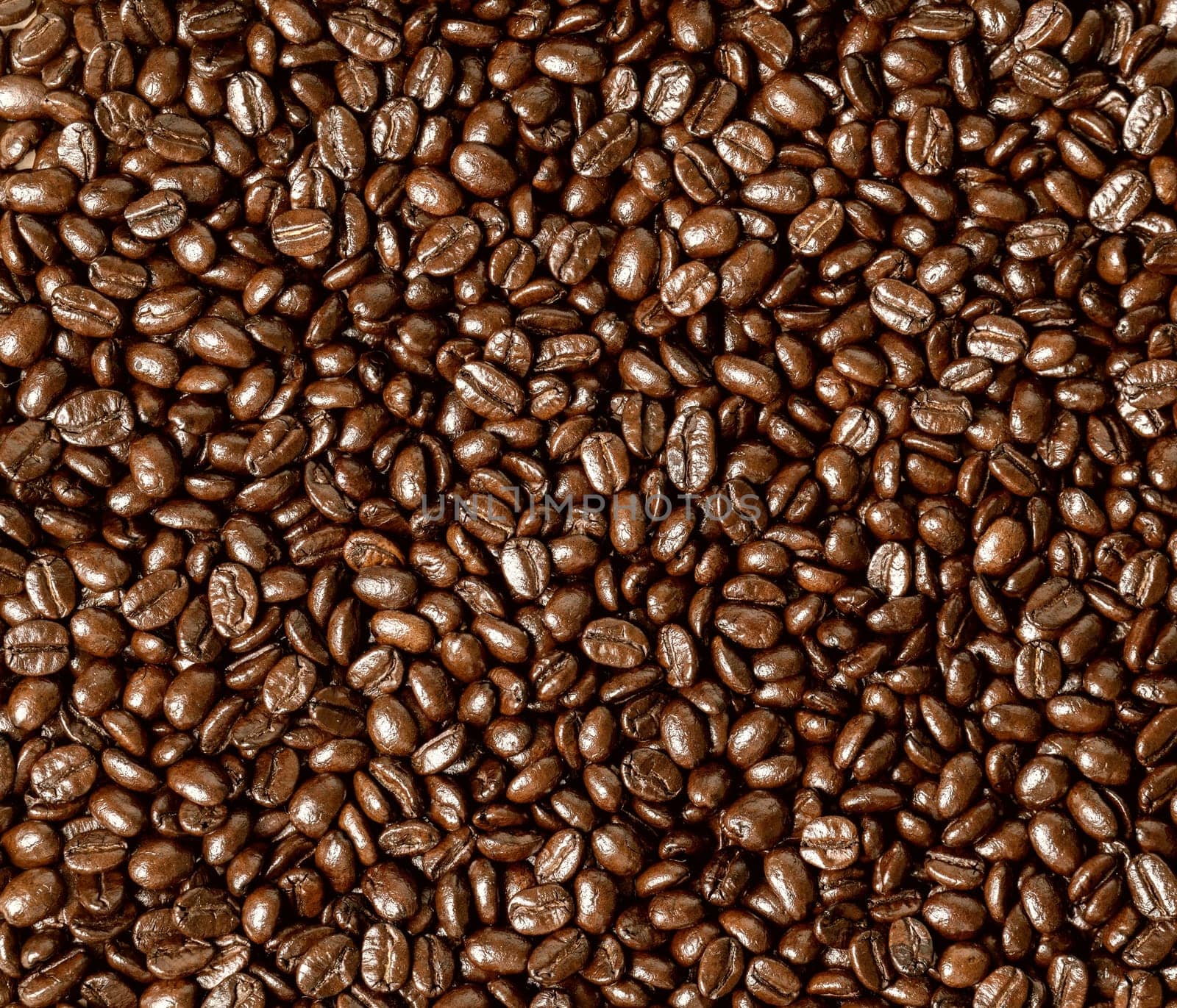 Roasted coffee beans on a flat background textured