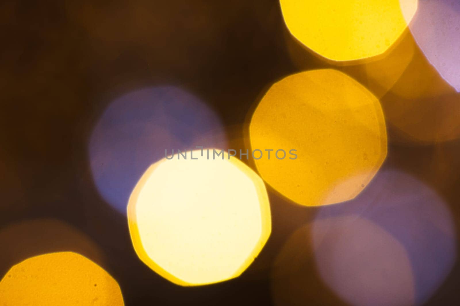 large gold and silver bokeh on a dark background.