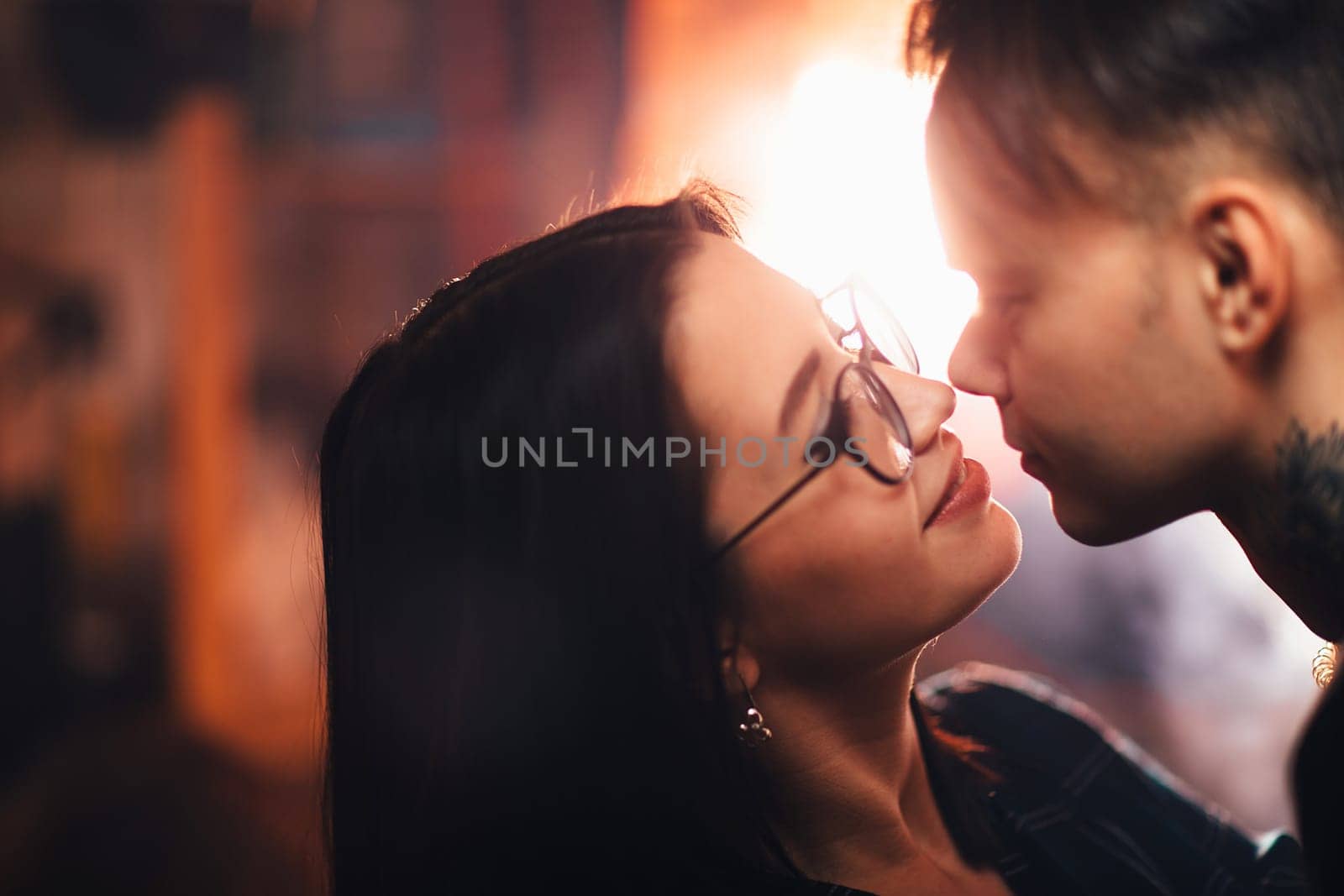 Couple in fashionable clothes on a shiny background.