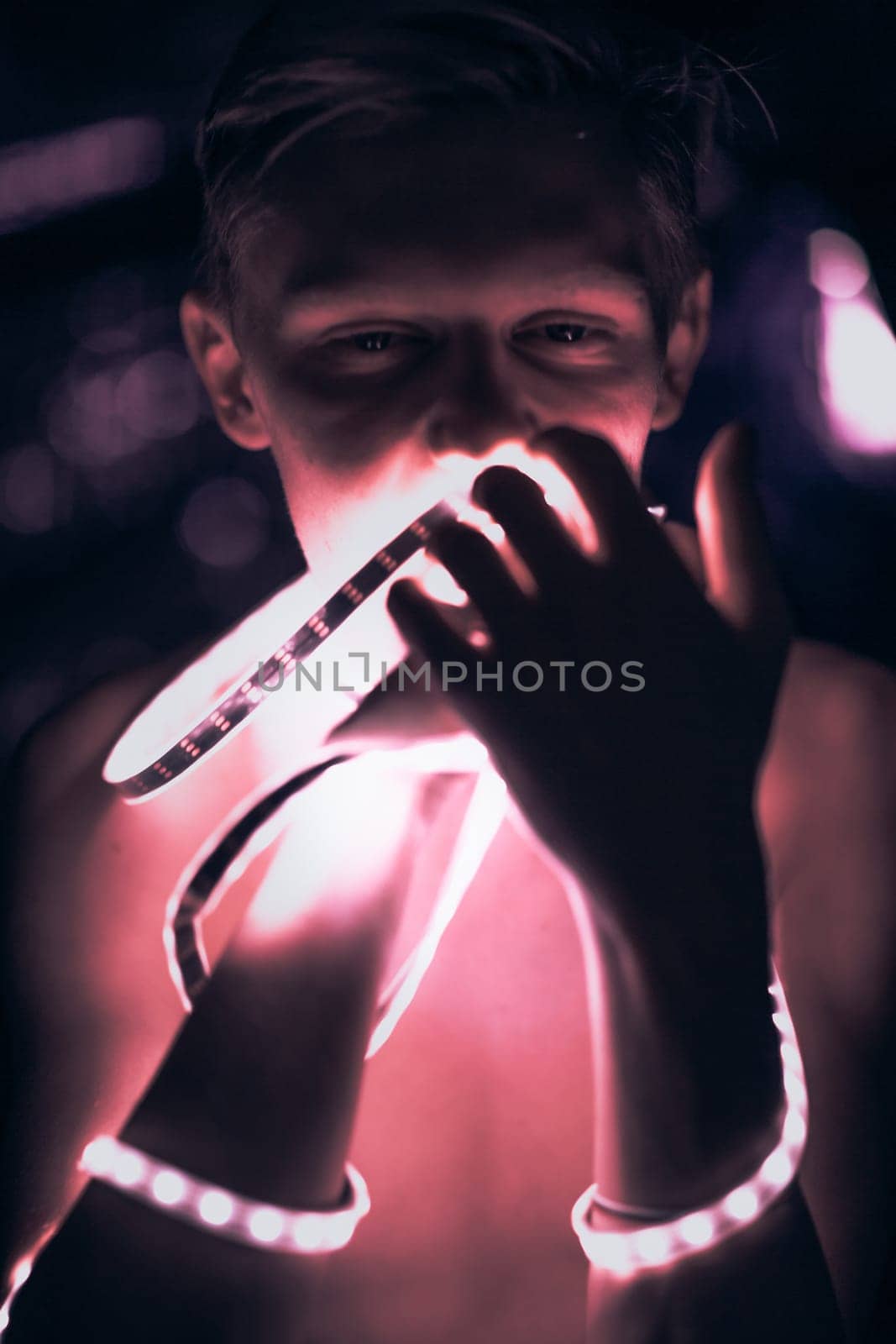 Portrait man Strip Light LED tape on dark color background.
