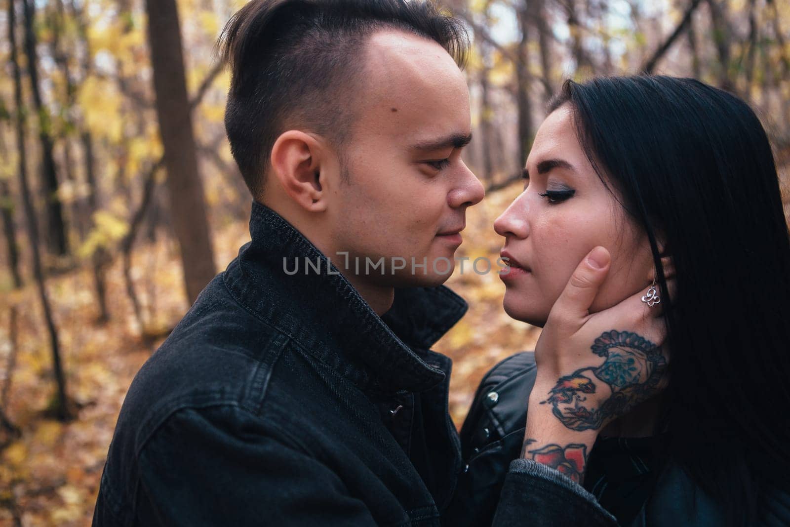 portrait of a young woman and a man walking in the autumn forest.