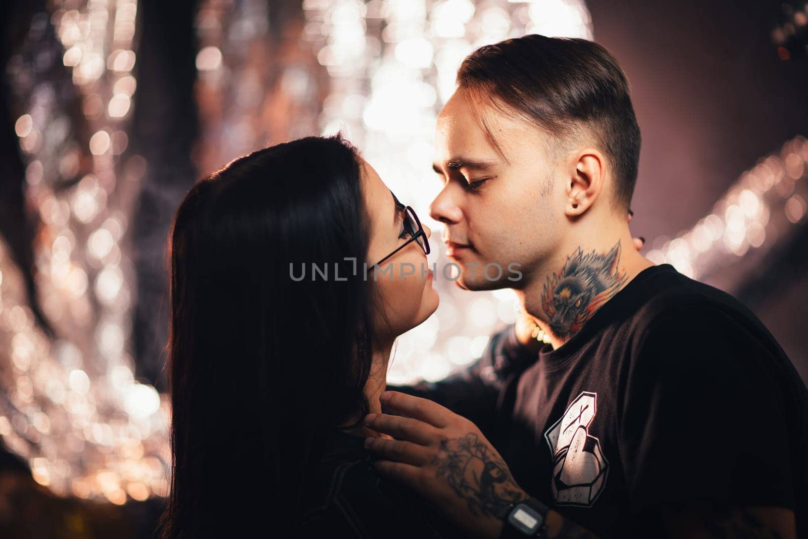 Couple in fashionable clothes on a shiny background.