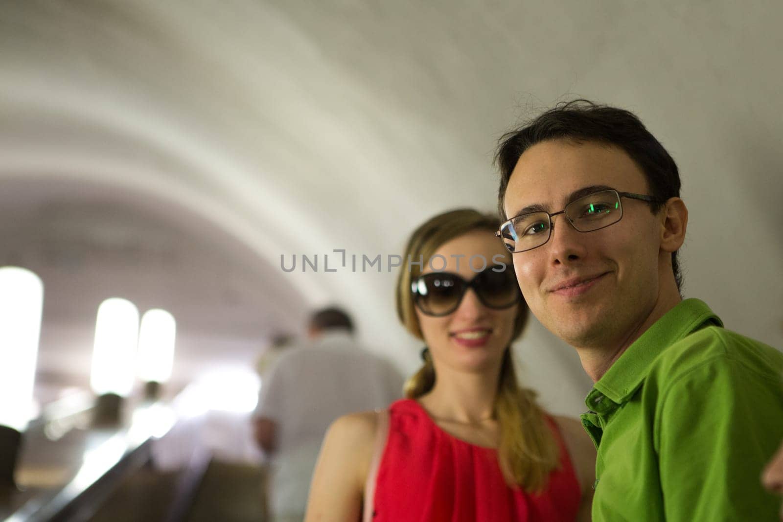 girl and guy on the background of the alley of garlands.