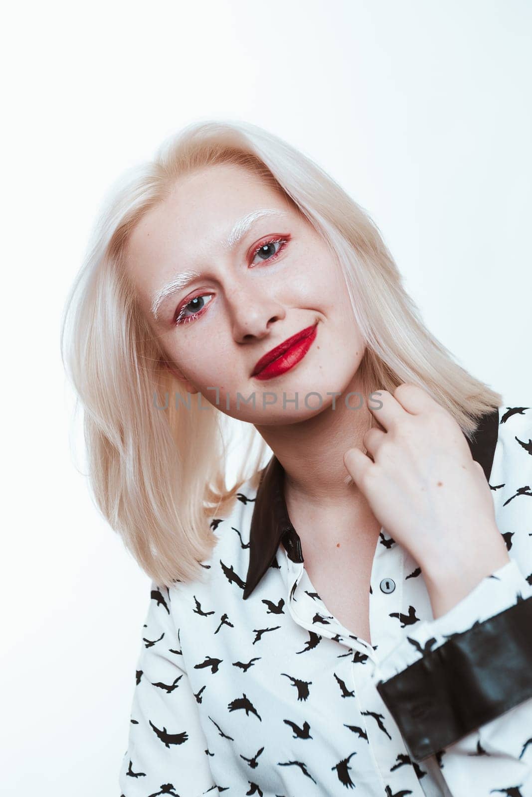 portrait blonde albino girl in studio on white background.