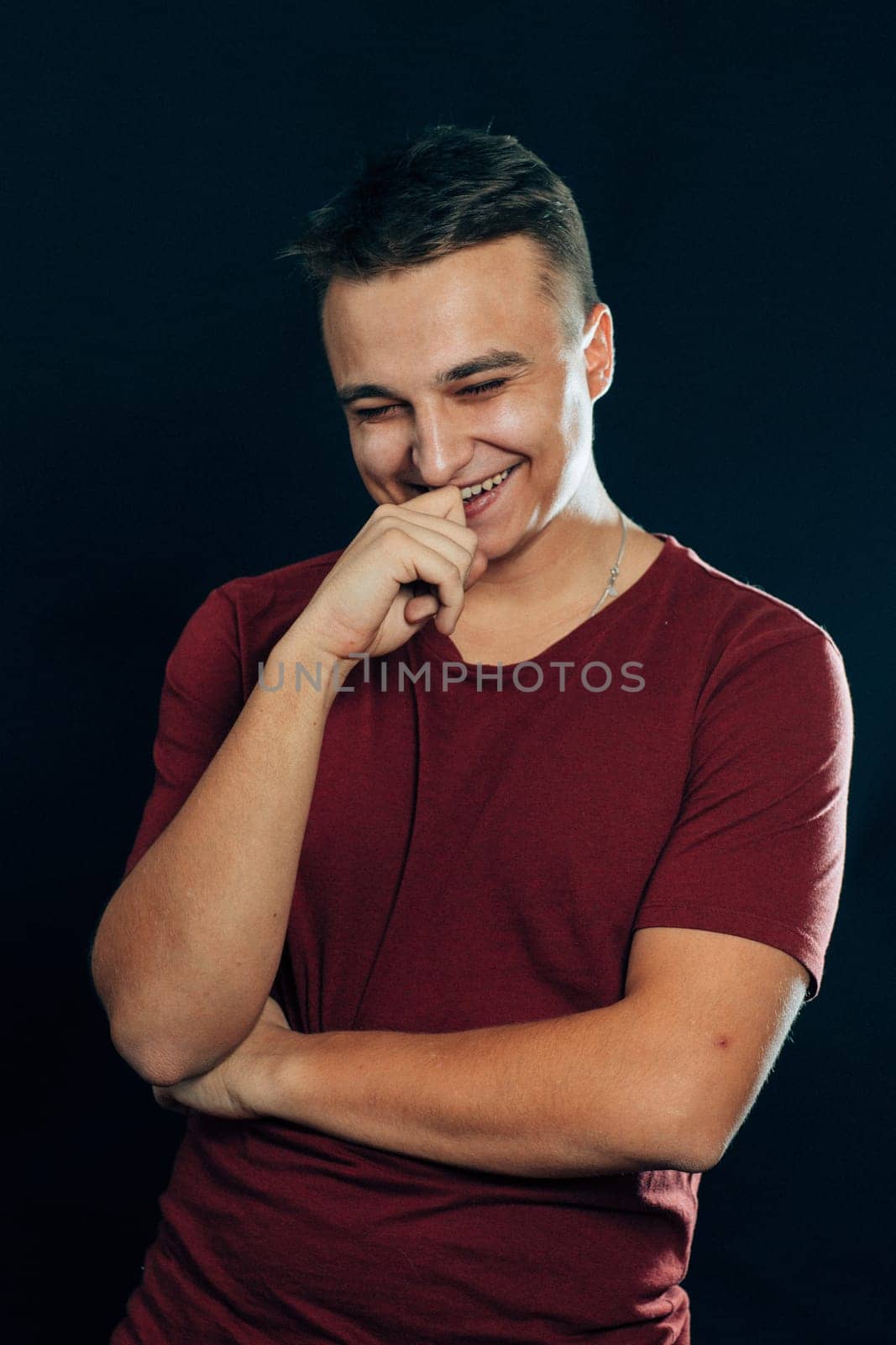 portrait of a young man on a dark background.