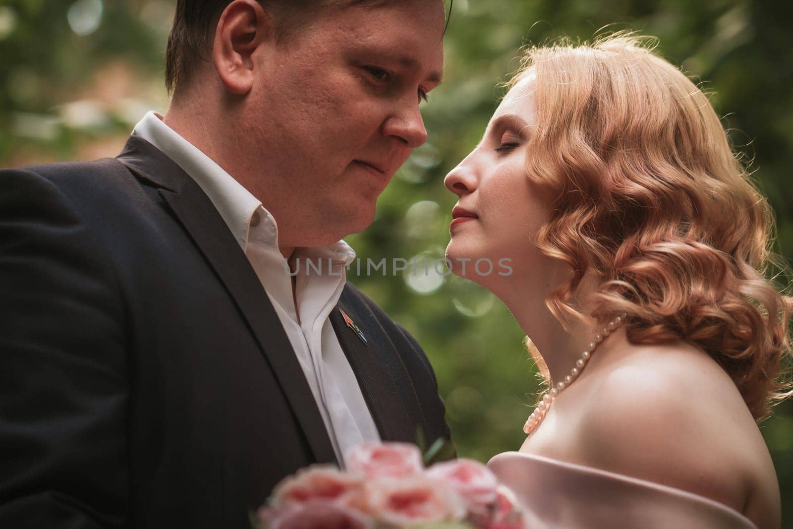 bride and groom dancing in the forest background and sunlight.