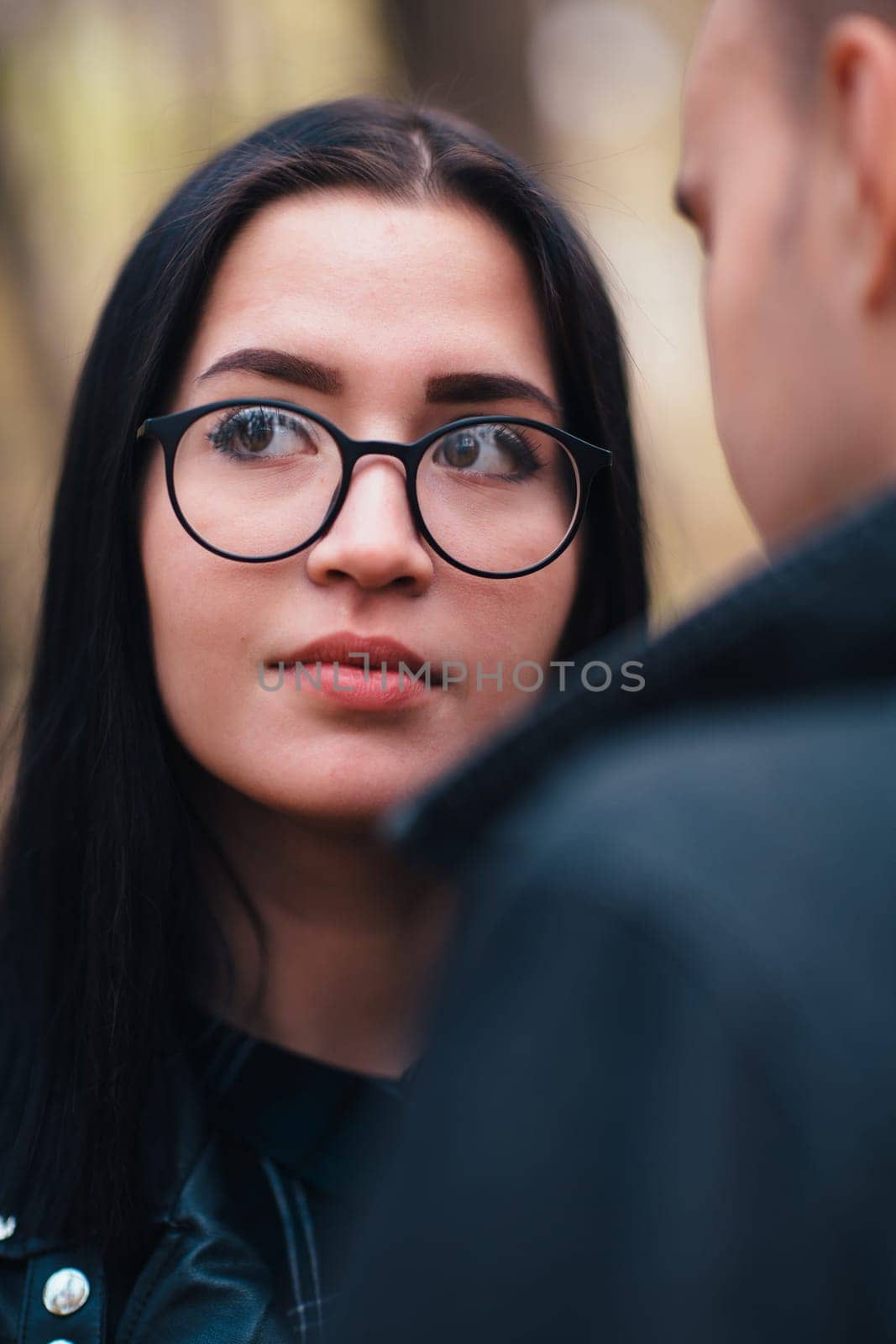 portrait of a young woman and a man walking in the autumn forest.