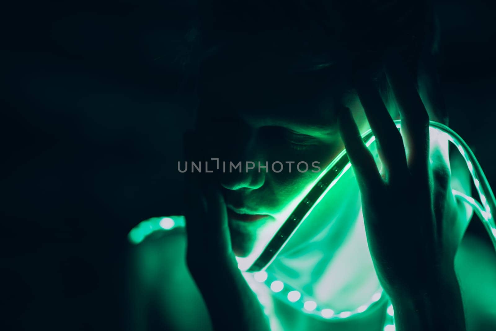 Portrait man Strip Light LED tape on dark color background.