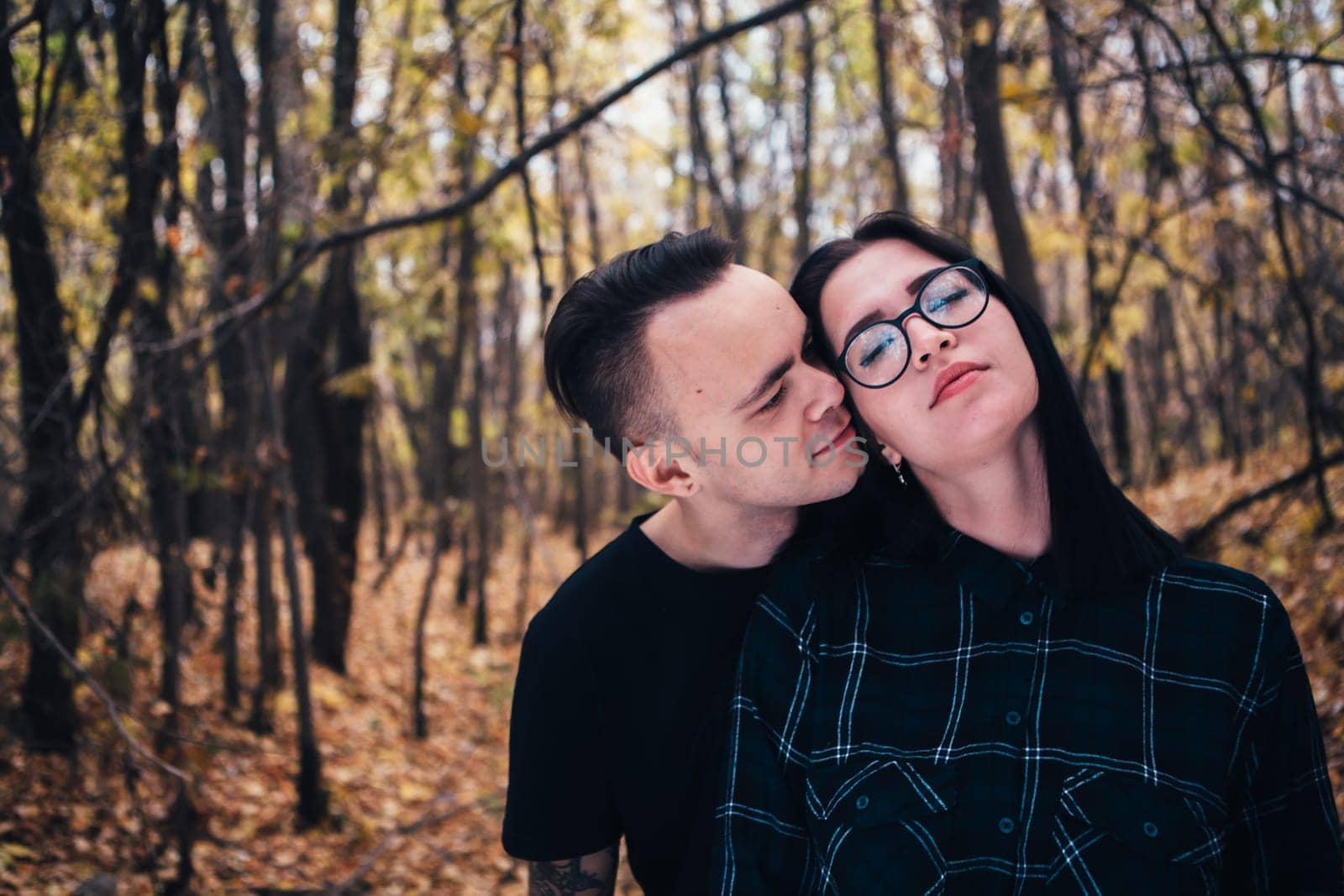 man and woman in the autumn forest