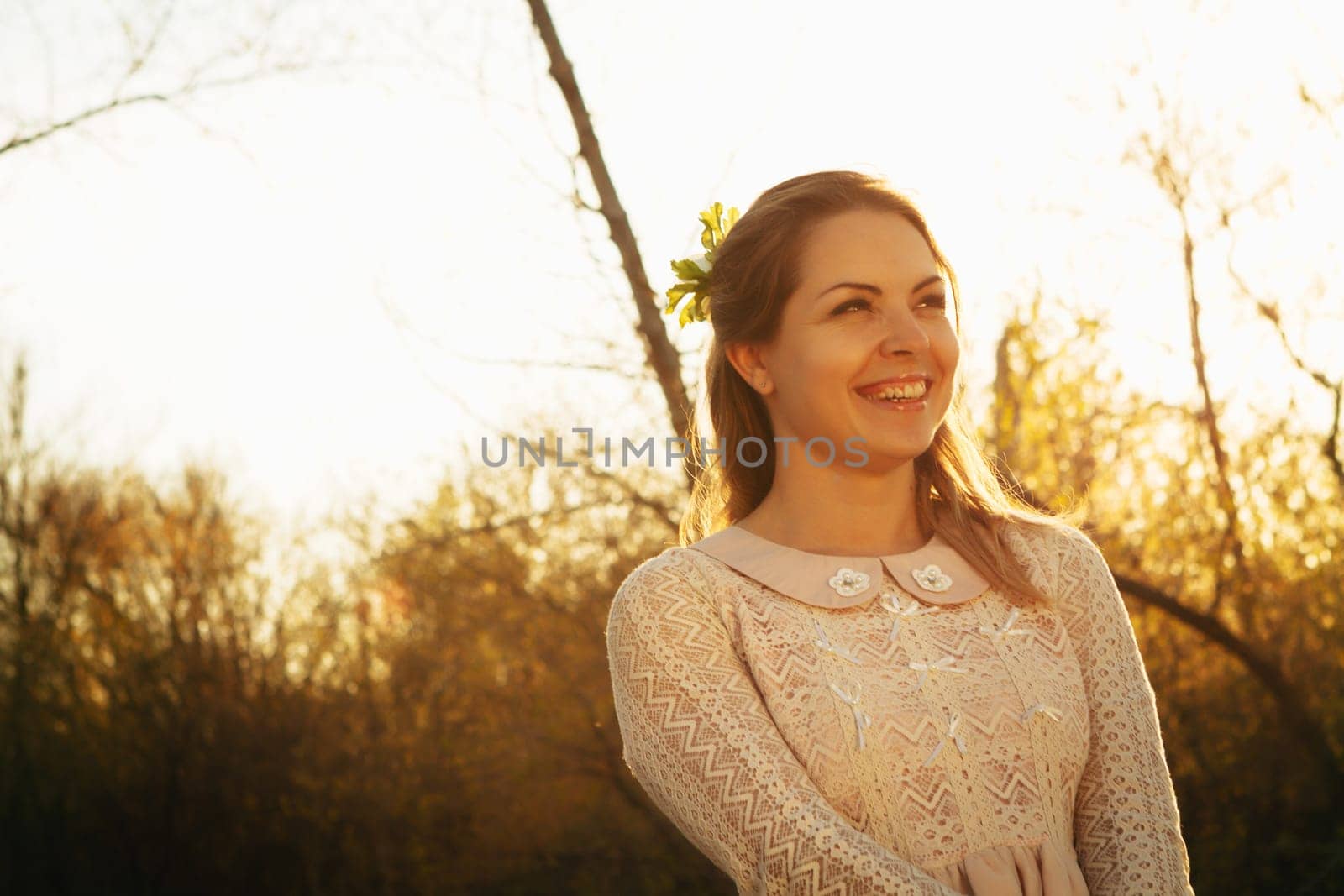 portrait of a girl in a field on a sunset background.