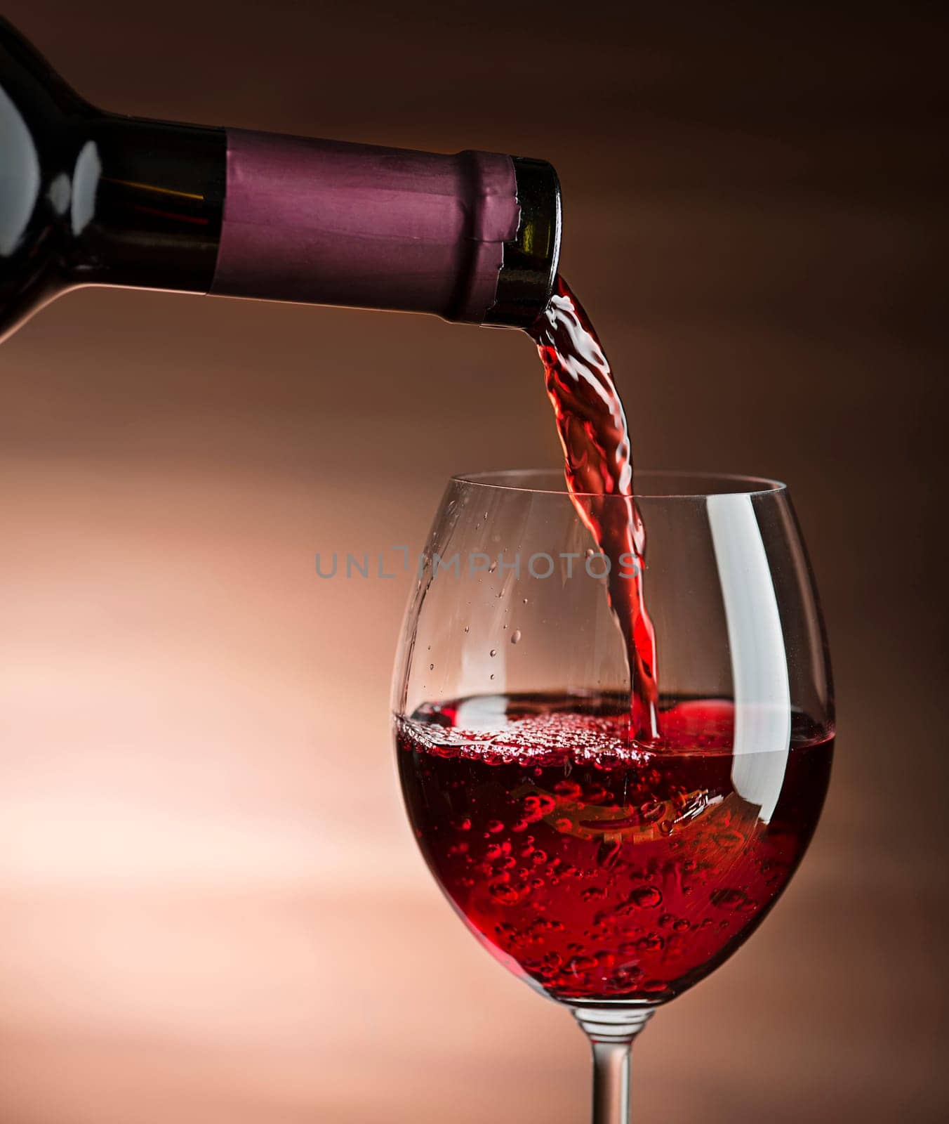 Red wine pouring into wine glass, close-up - Image