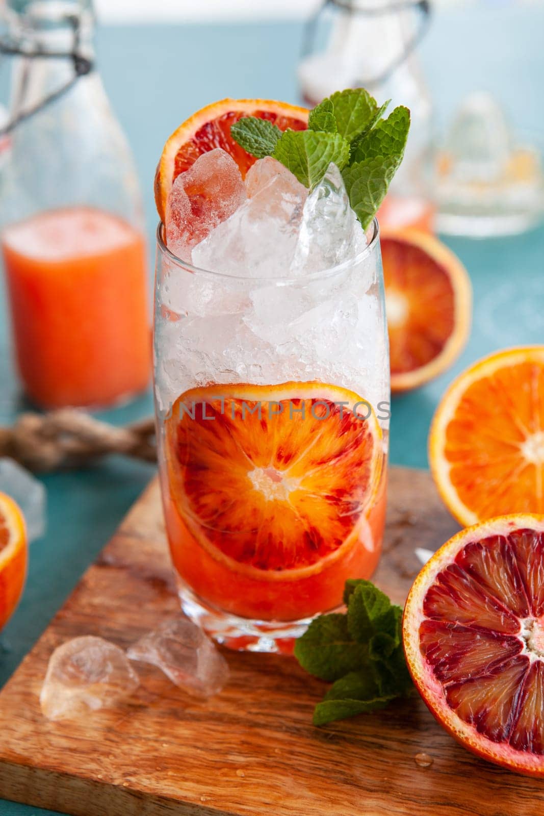 Cold cocktail with fresh bloodoranges and mint leaves