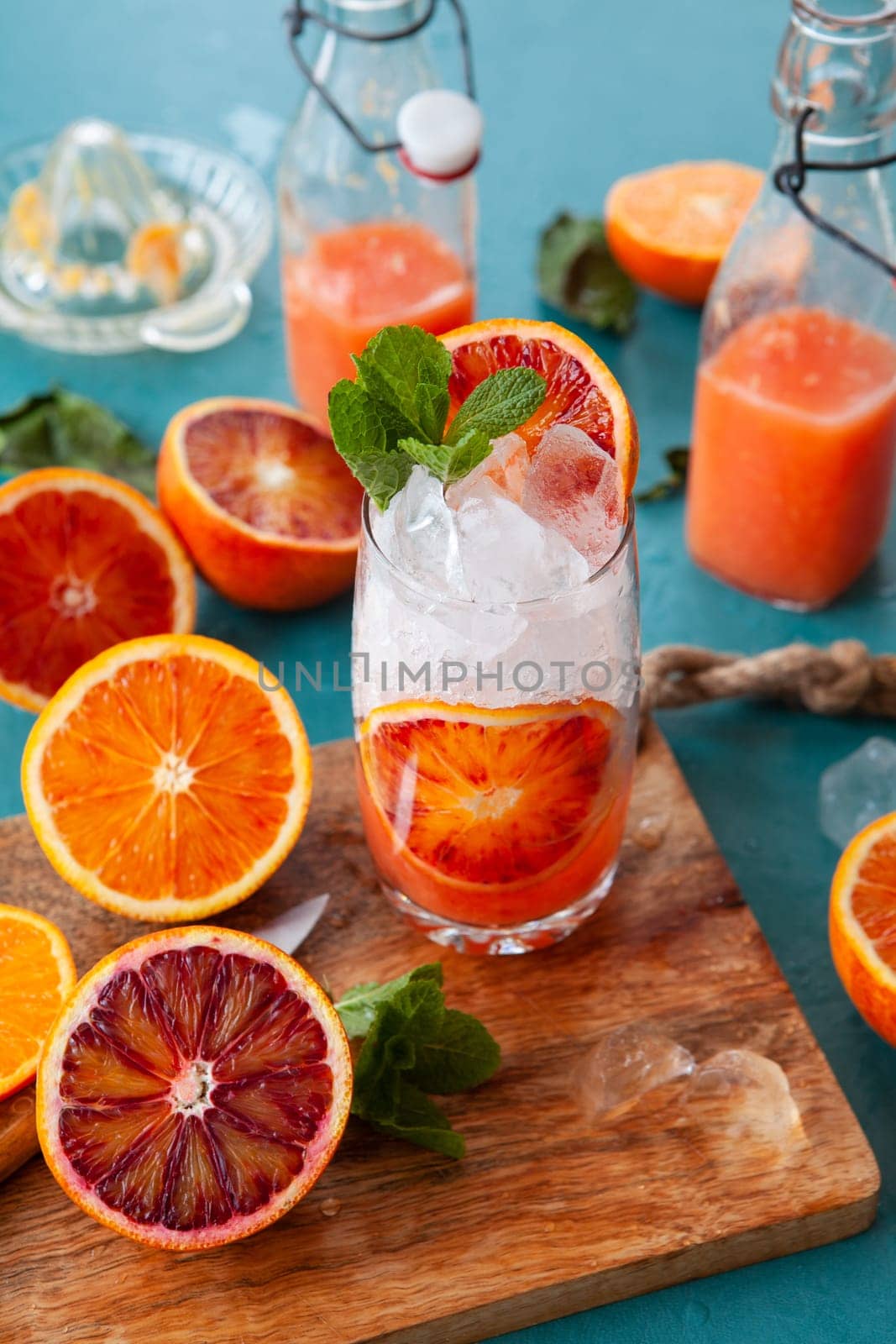 Cold cocktail with fresh bloodoranges and mint leaves