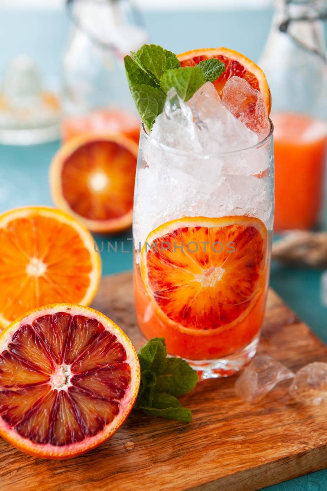 Cold cocktail with fresh bloodoranges and mint leaves