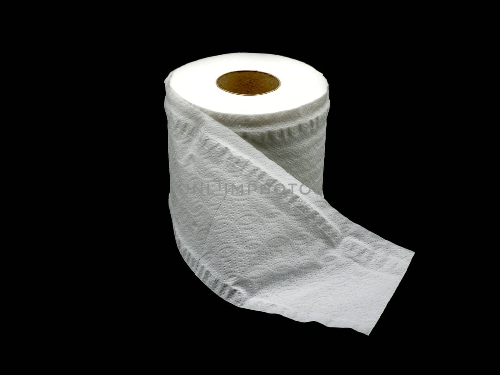 Tissue paper with roll core. Roll of toilet paper isolated on a black background.