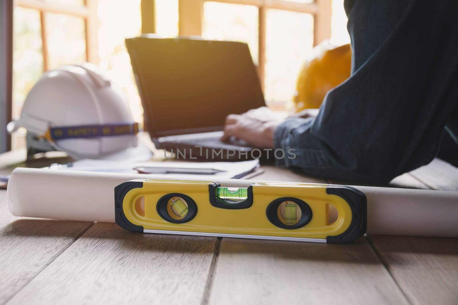 Architect engineer working concept with laptop and construction tools or safety equipment on table.