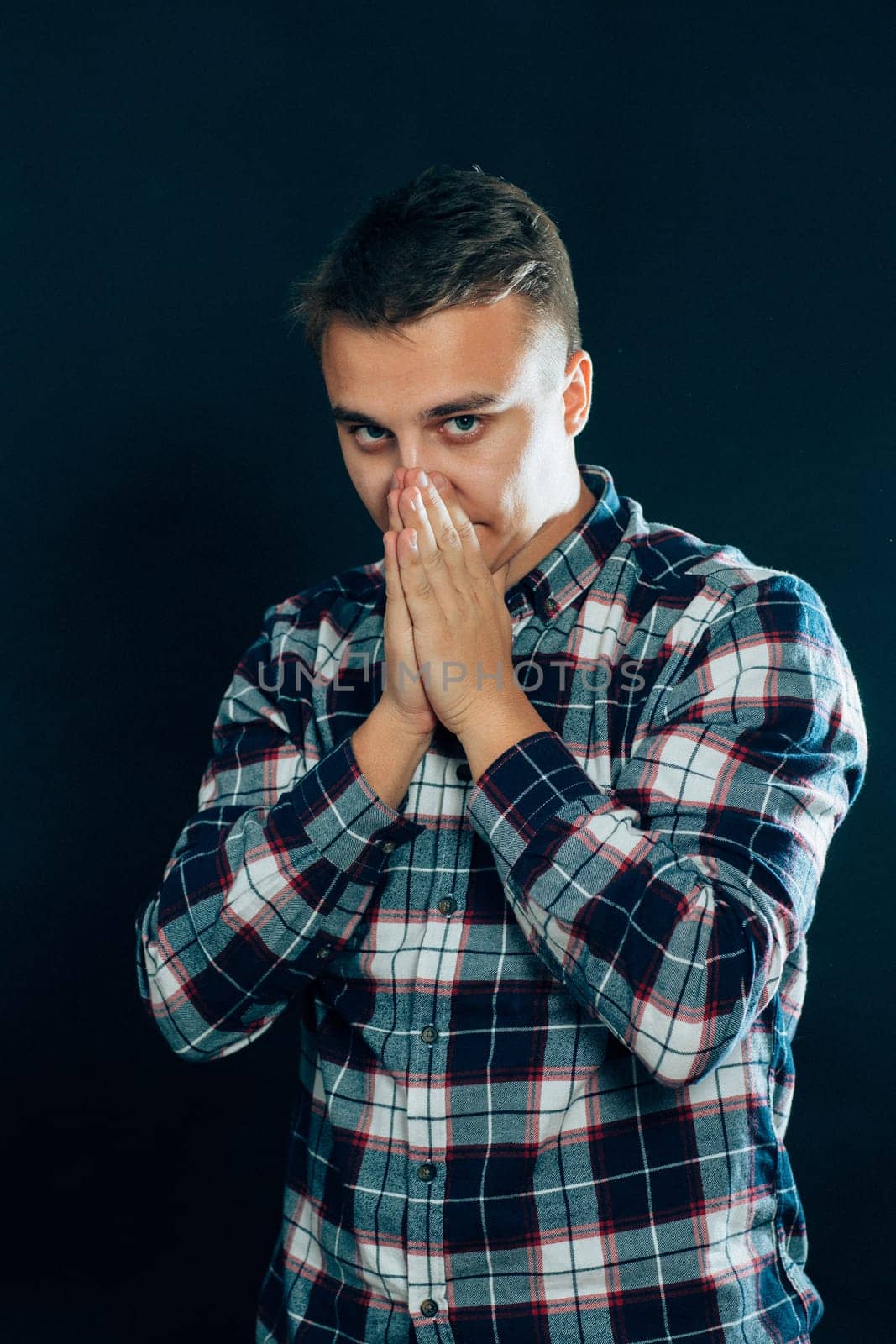 portrait of a young man on a dark background.