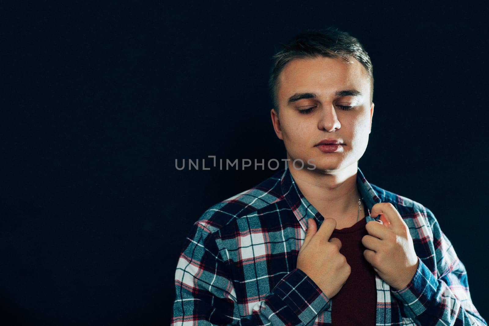 portrait of a young man on a dark background.