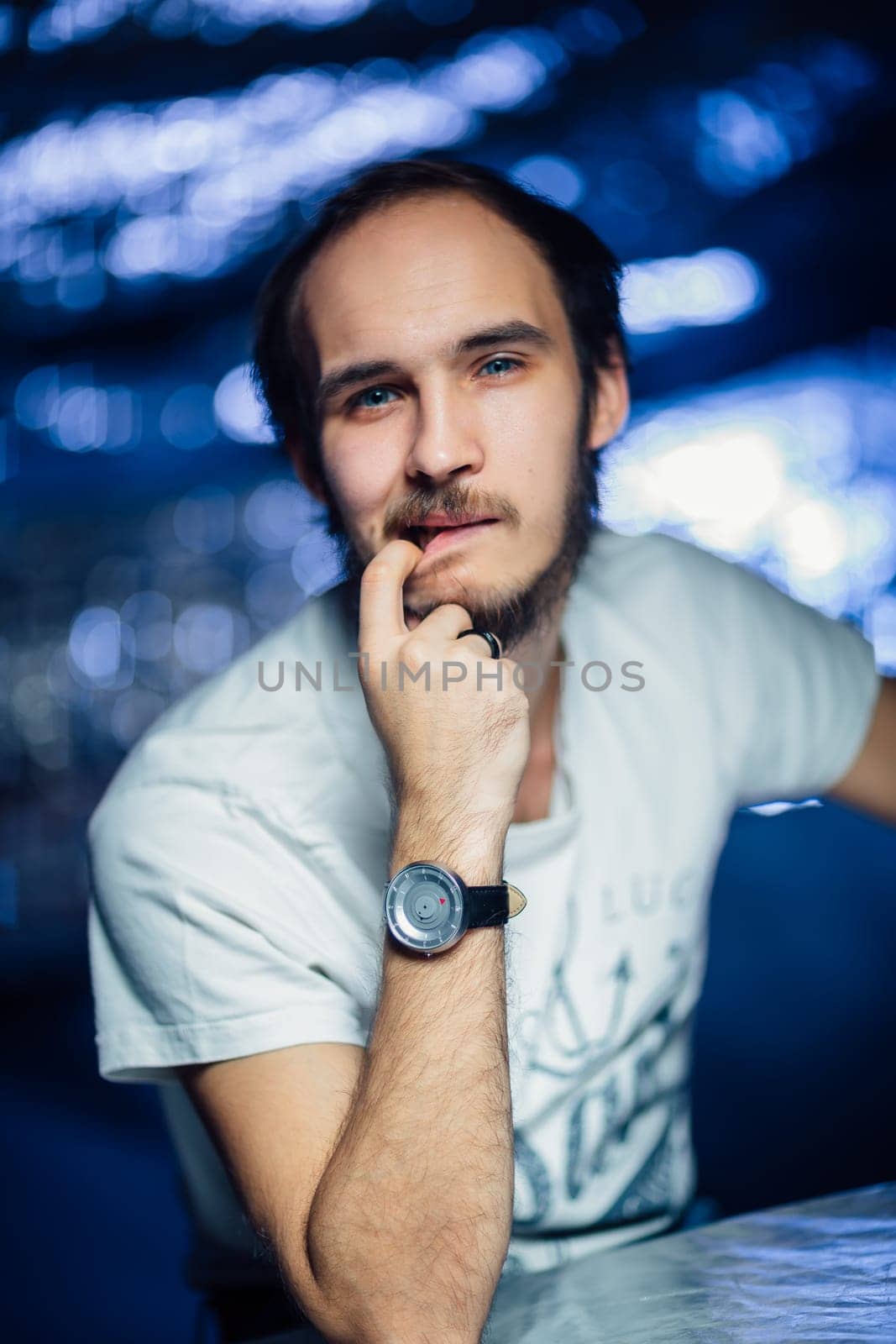 portrait of a guy in a hat on a blurred background.