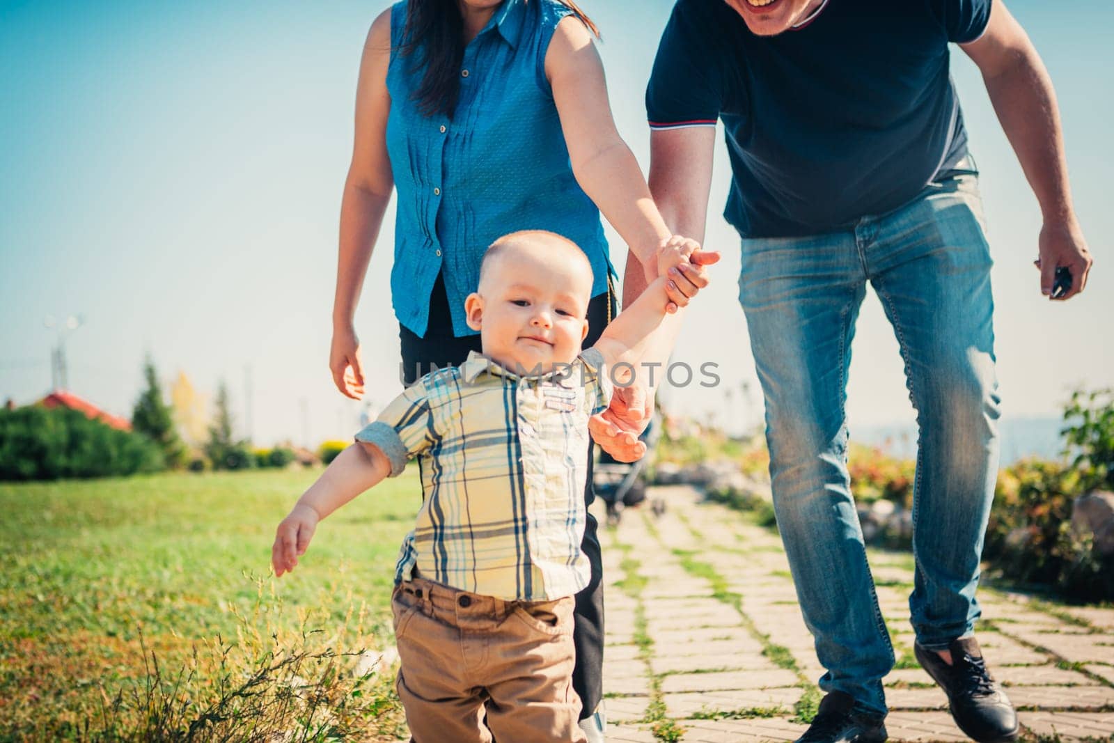 Happy family with baby son on nature background.