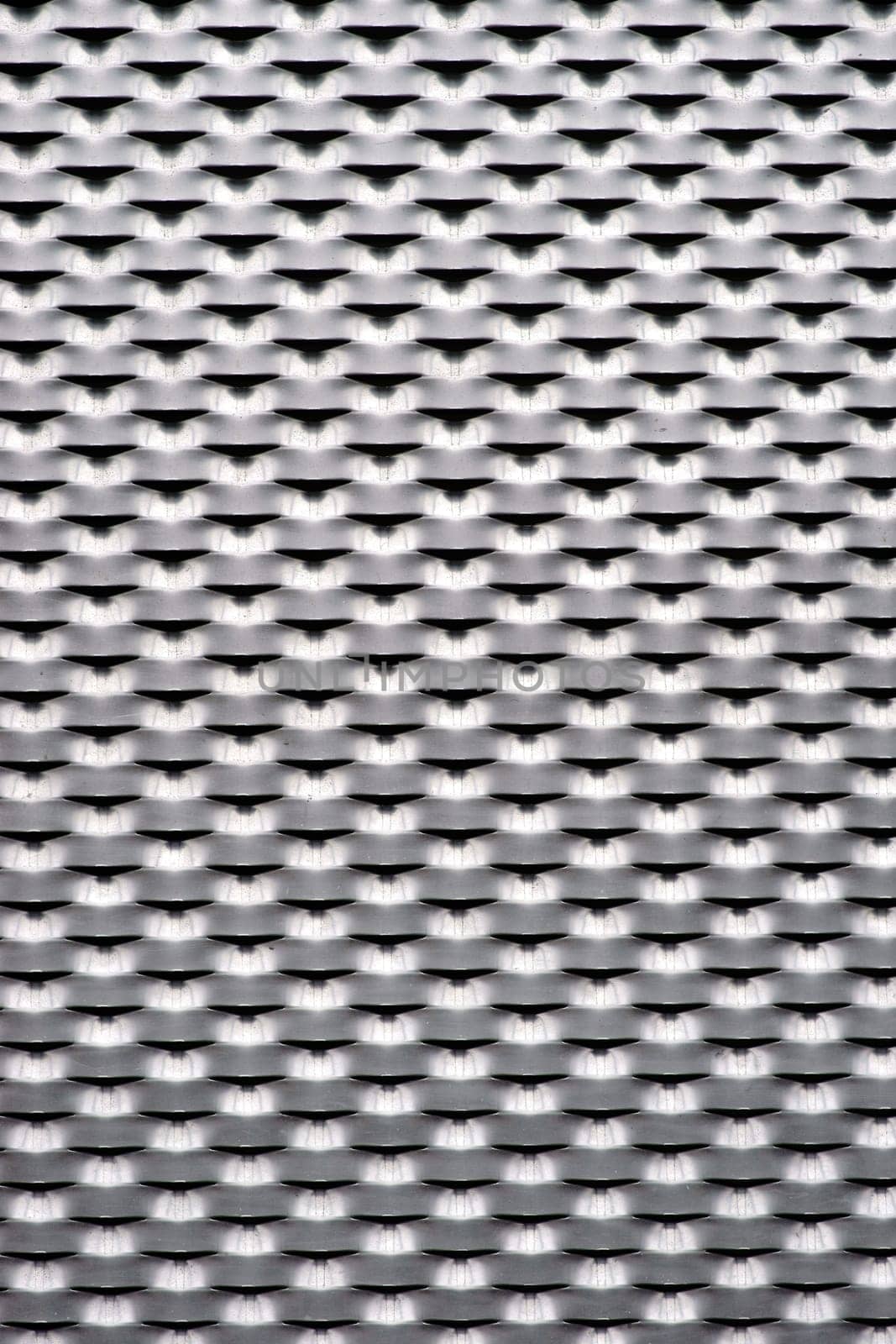 The close-up of a stamped corrugated sheet and expanded metal.....