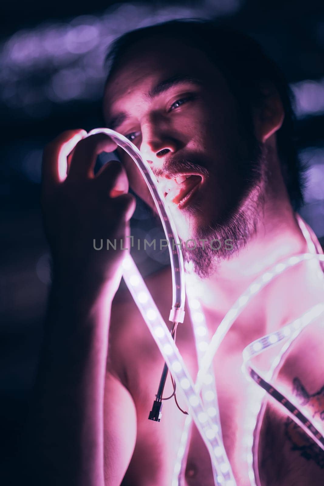 Portrait man Strip Light LED tape on dark color background.