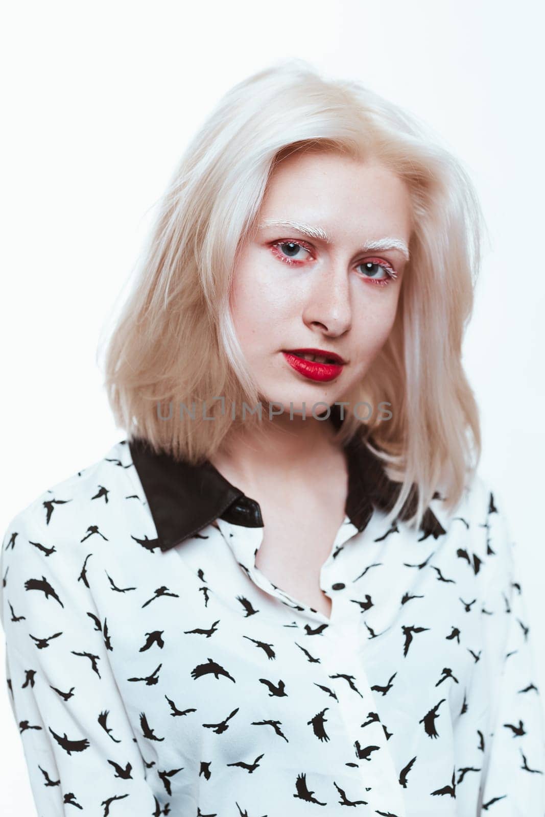 portrait blonde albino girl in studio on white background.
