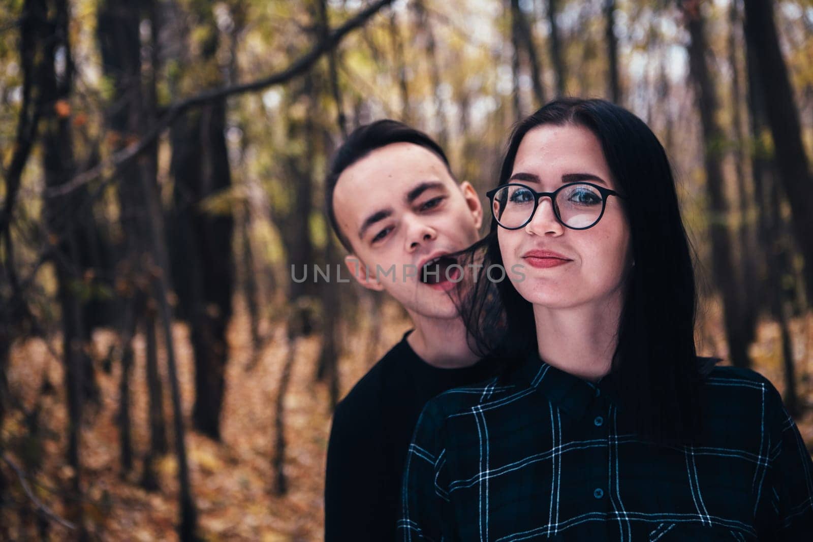 man and woman in the autumn forest