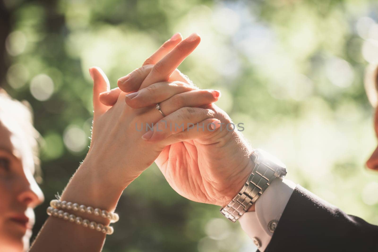 hands bride and groom on blurred background.