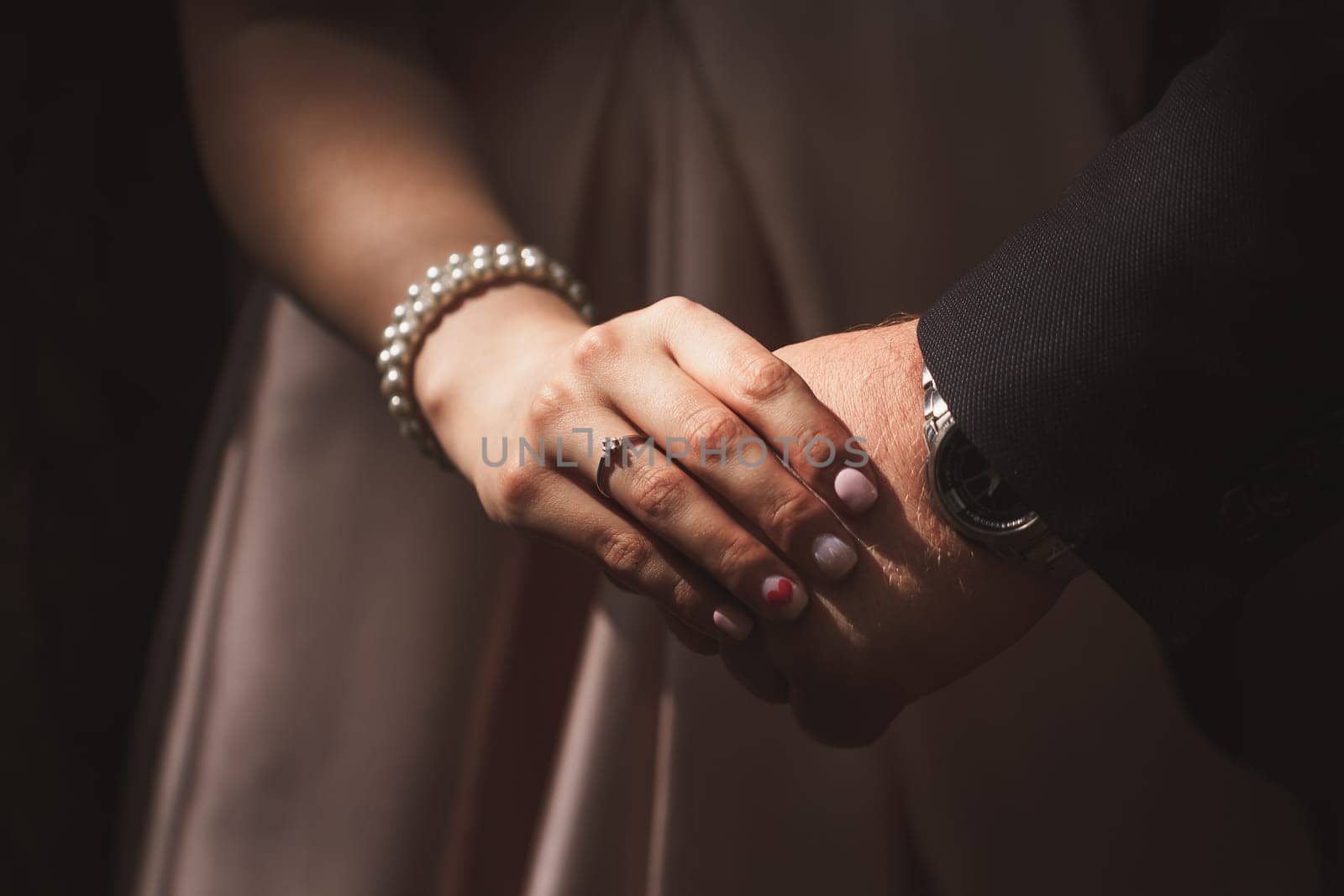 hands bride and groom on blurred background.