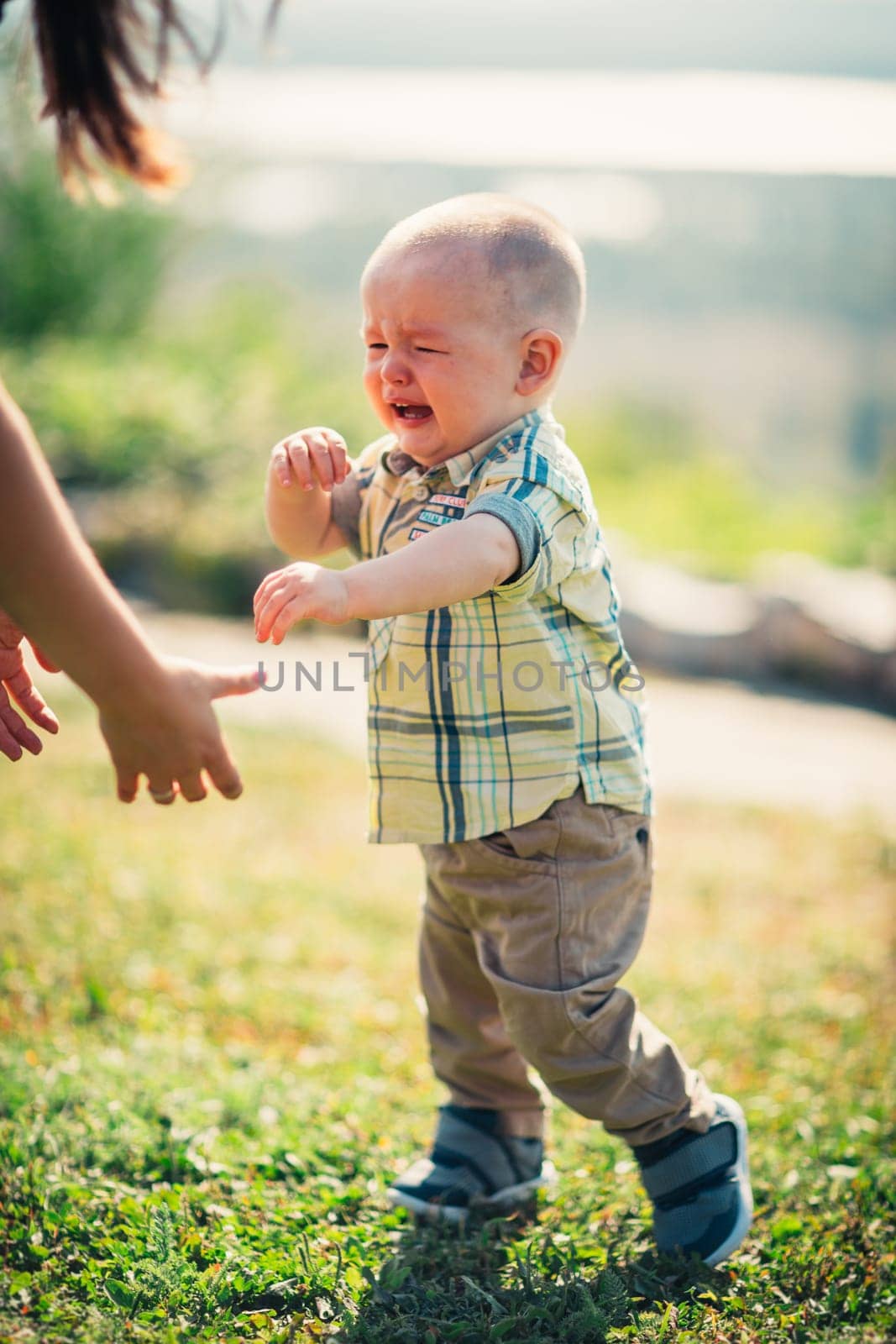 crying toddler baby on nature background.