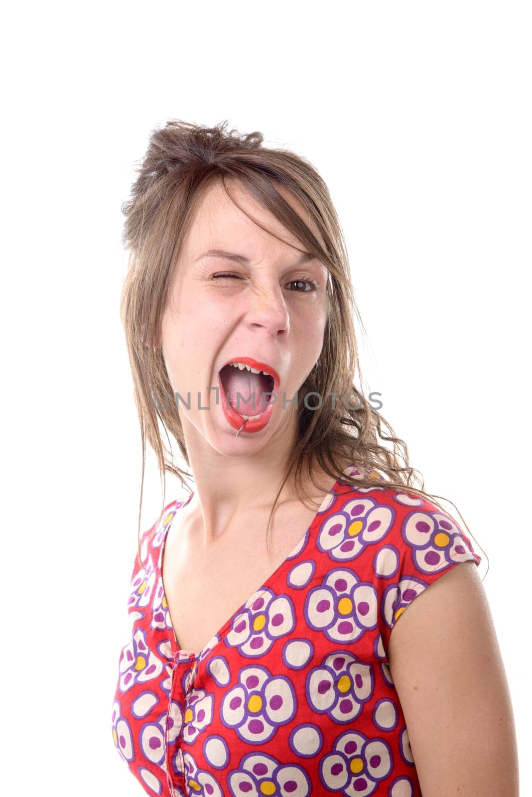 a young woman of twenty makes a grimace on white