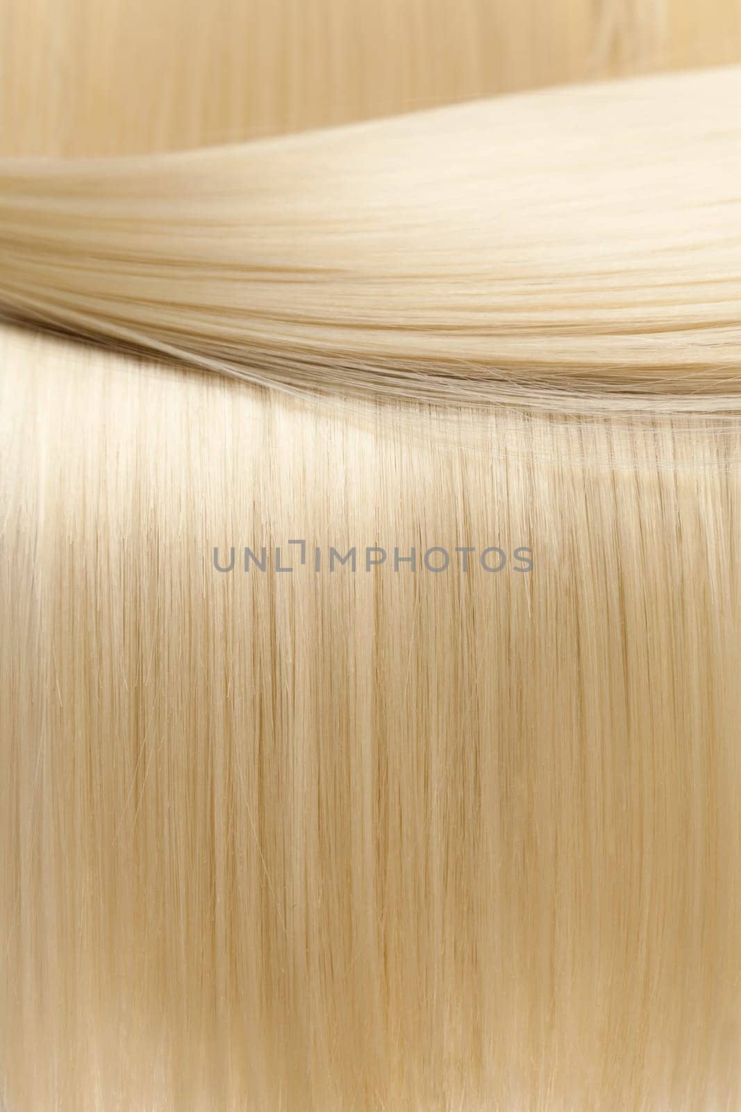 Closeup on luxurious straight glossy blonde hair
