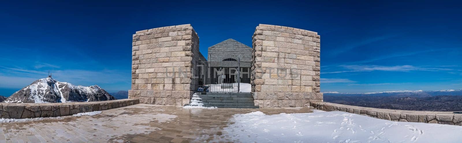 Mt Lovcen, Montenegro - April 2018 : Panoramic view of the two tall statues guarding the entrance to the Njegos Mausoleum on Mount Lovcen