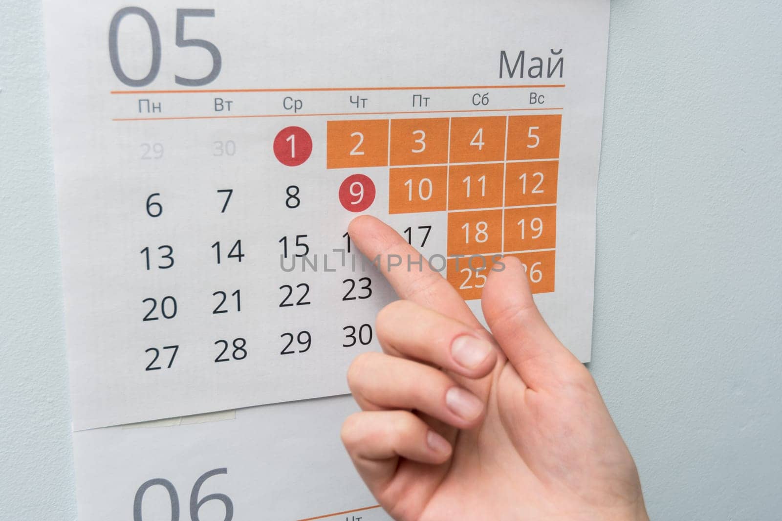 The hand points to the long May holidays holiday in the wall calendar