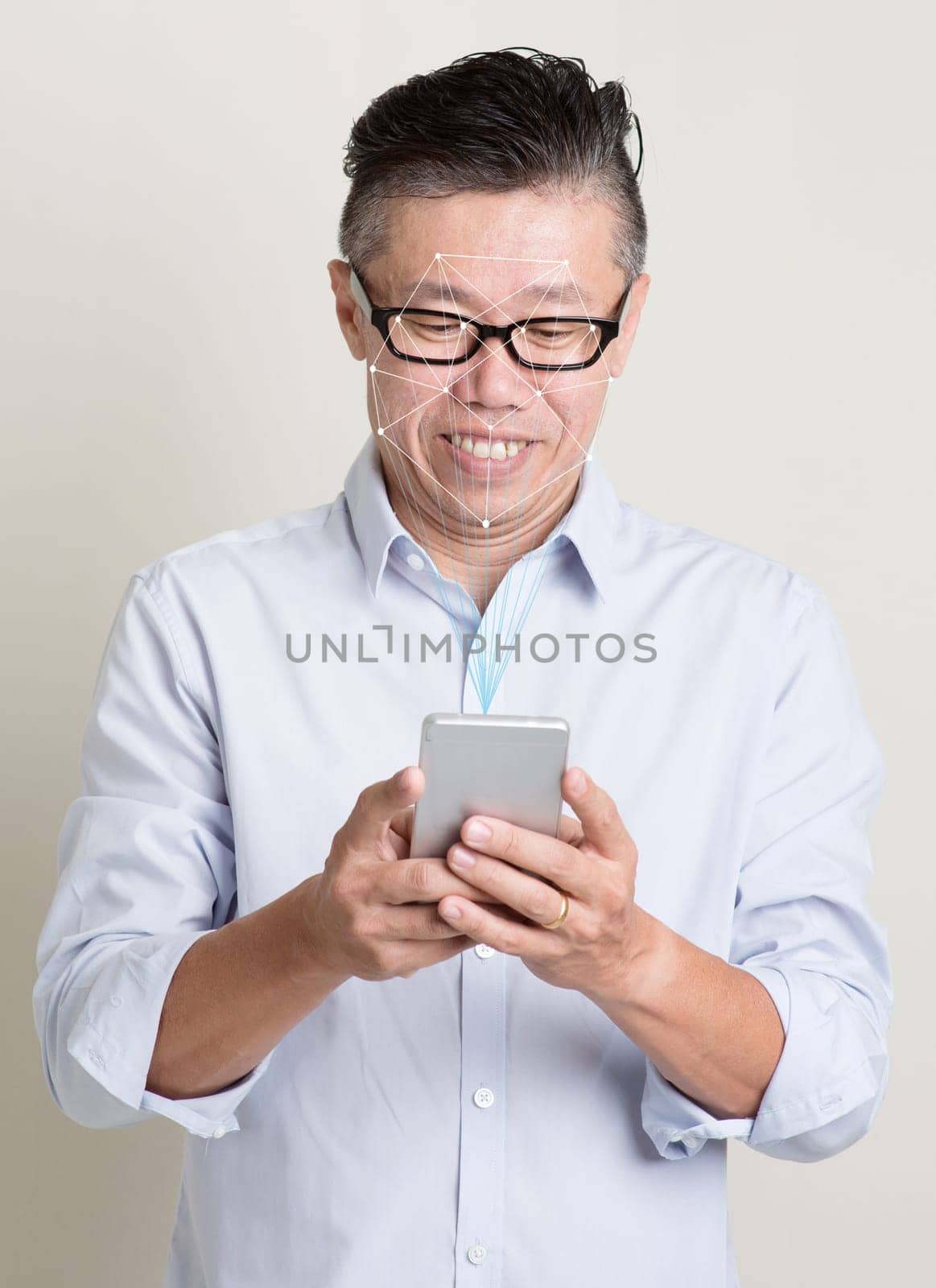 Futuristic and technology. Concept of scanning Asian man face with smartphone for facial recognition.