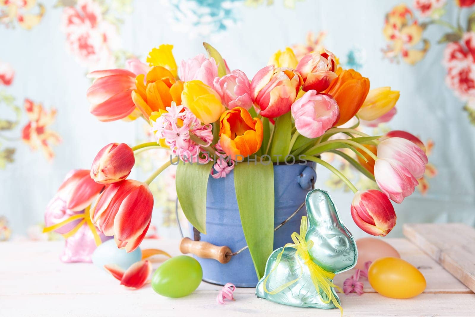 Colorful spring flowers in a little vintage bucket