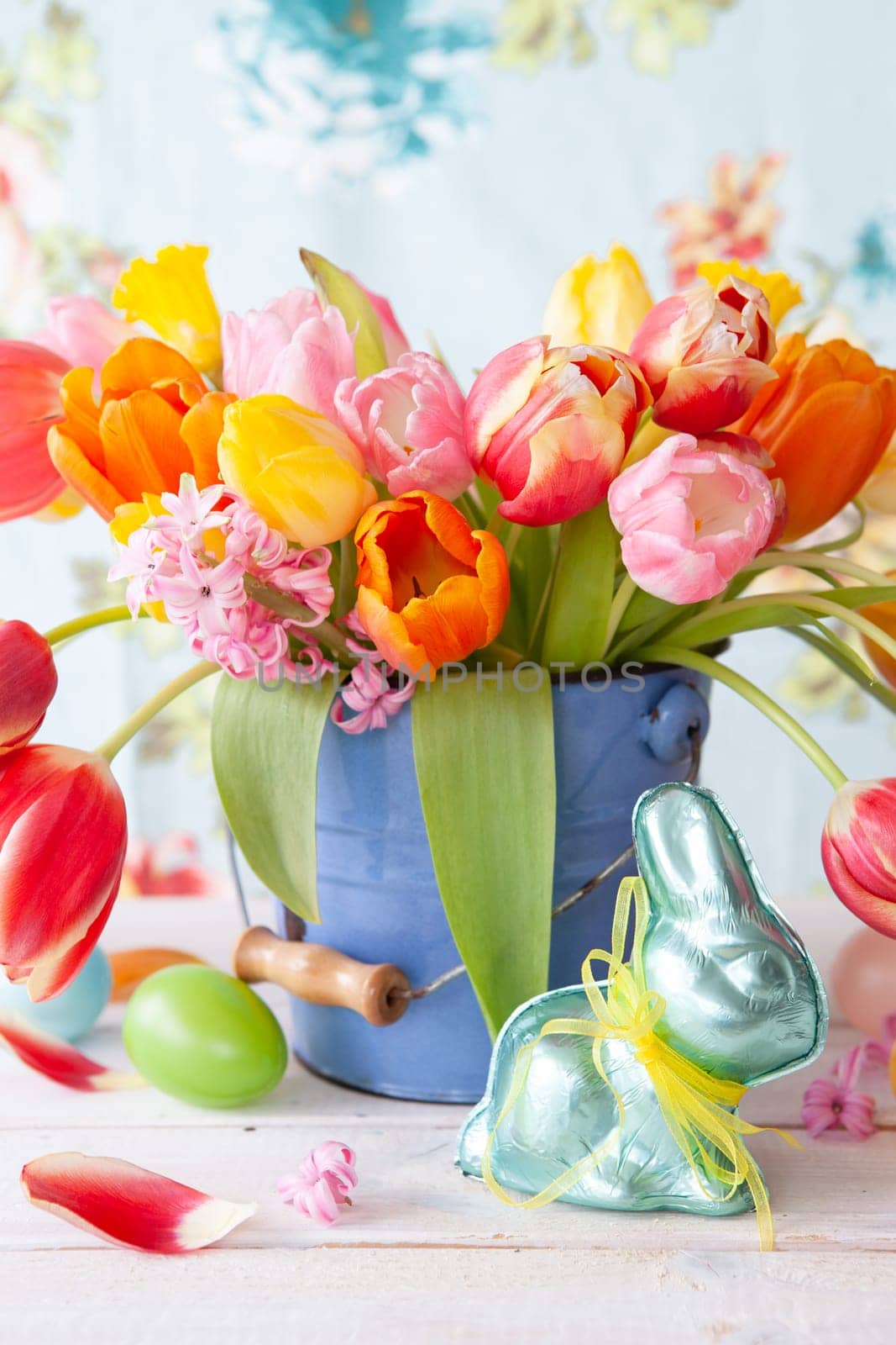 Colorful spring flowers in a little vintage bucket