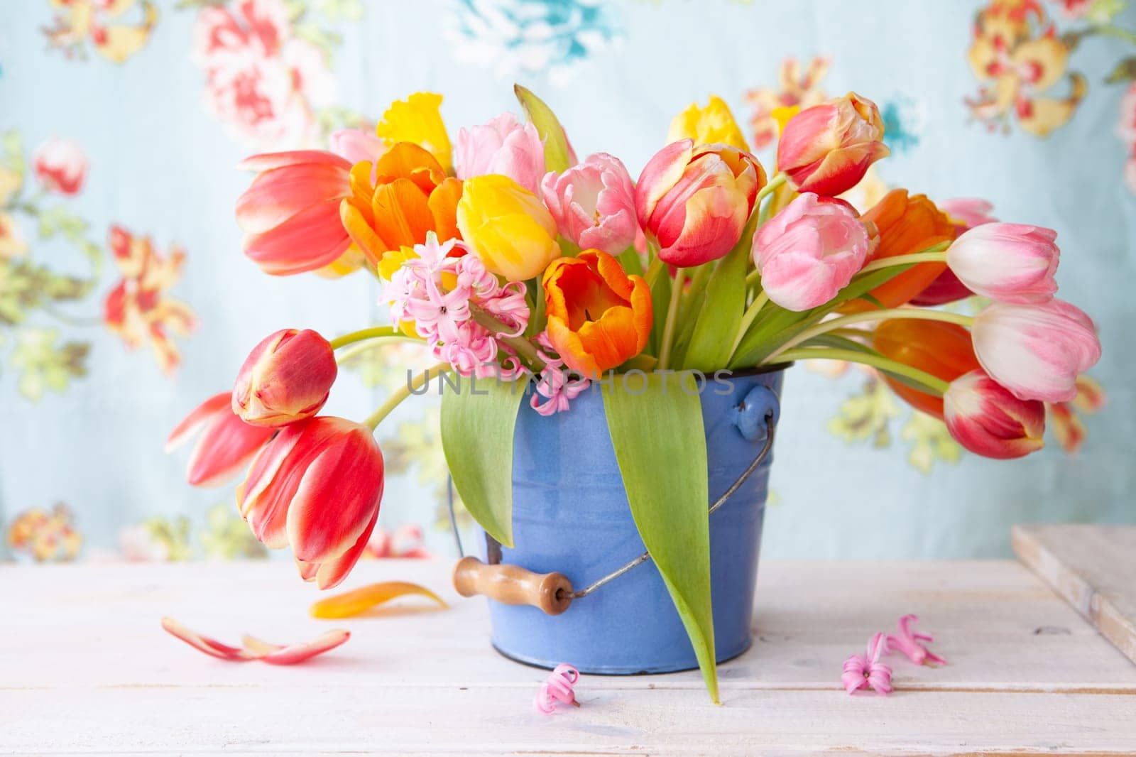Colorful spring flowers in a little vintage bucket