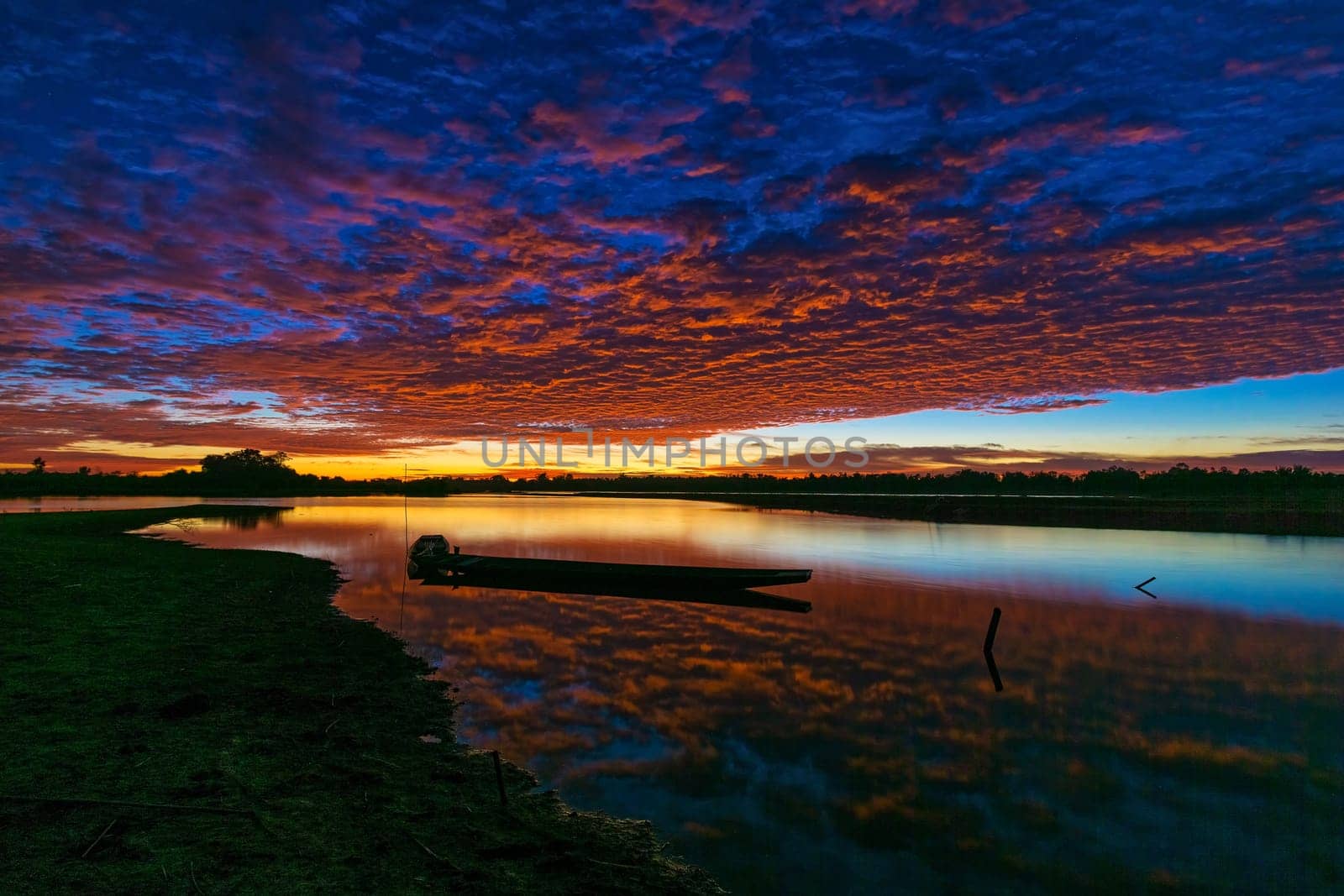 Sunrise With Lake Reflection, idyllic landscape with boat and cumulus clouds