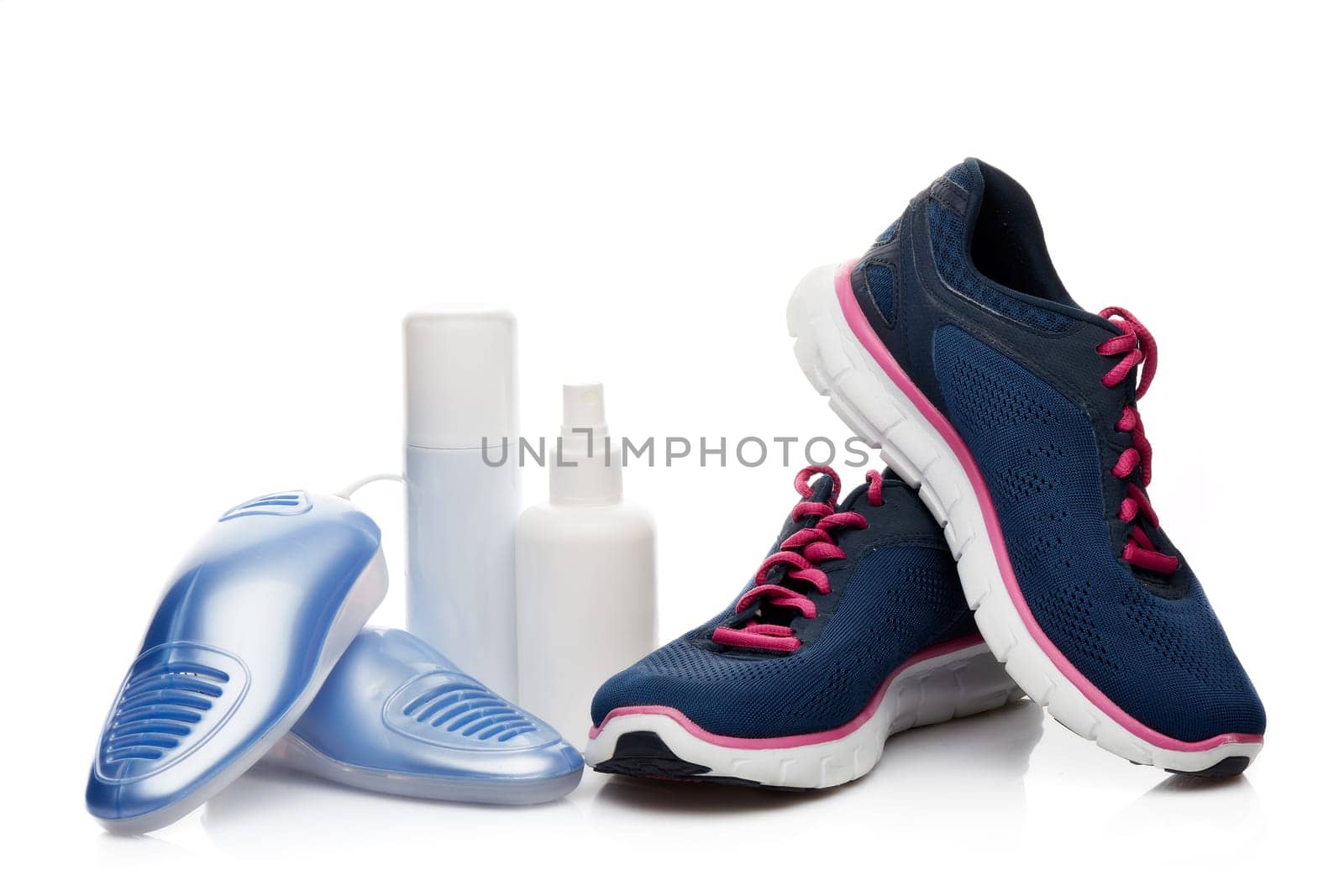 Sports shoes care. Electric shoes dryer with UV sterilization on a white background, Deodorant for shoe and antifungal agent. Shoe care products. Concept of healthy feet. Fitness and sport footwear