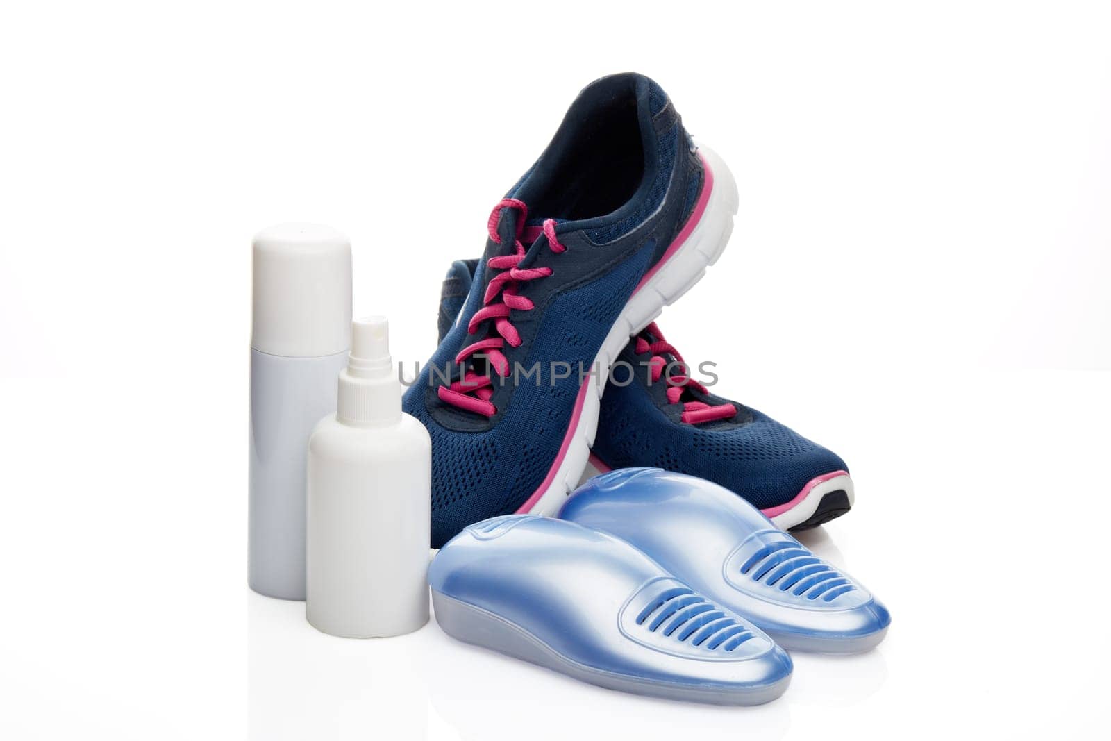 Sports shoes care. Electric shoes dryer with UV sterilization on a white background, Deodorant for shoe and antifungal agent. Shoe care products. Concept of healthy feet. Fitness and sport footwear