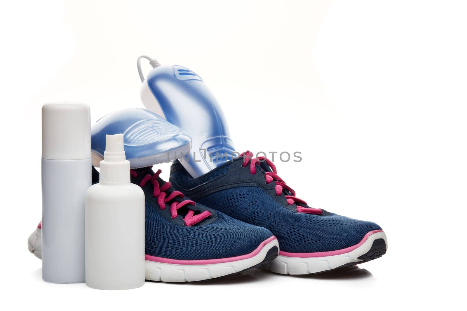 Sports shoes care. Electric shoes dryer with UV sterilization on a white background, Deodorant for shoe and antifungal agent. Shoe care products. Concept of healthy feet. Fitness and sport footwear